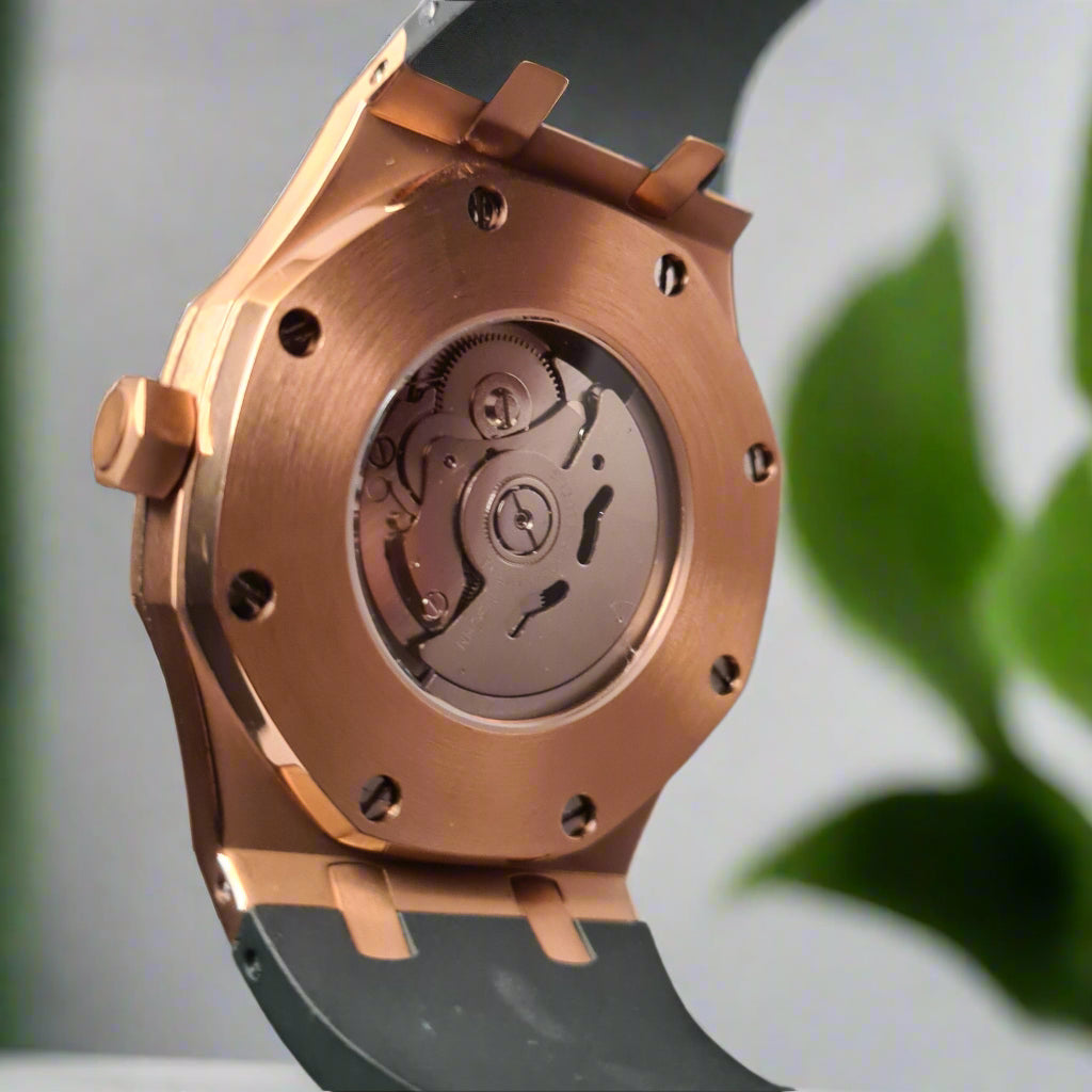 Close-up of a mechanical watch movement being held by a hand