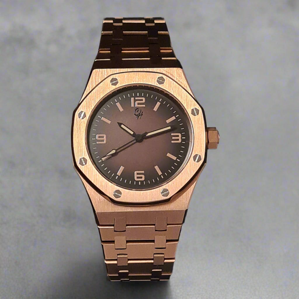 Rose gold watch with brown dial on a gray background