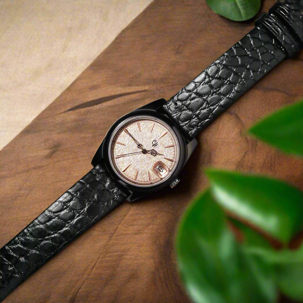Wristwatch with black leather strap on a dark gray background
