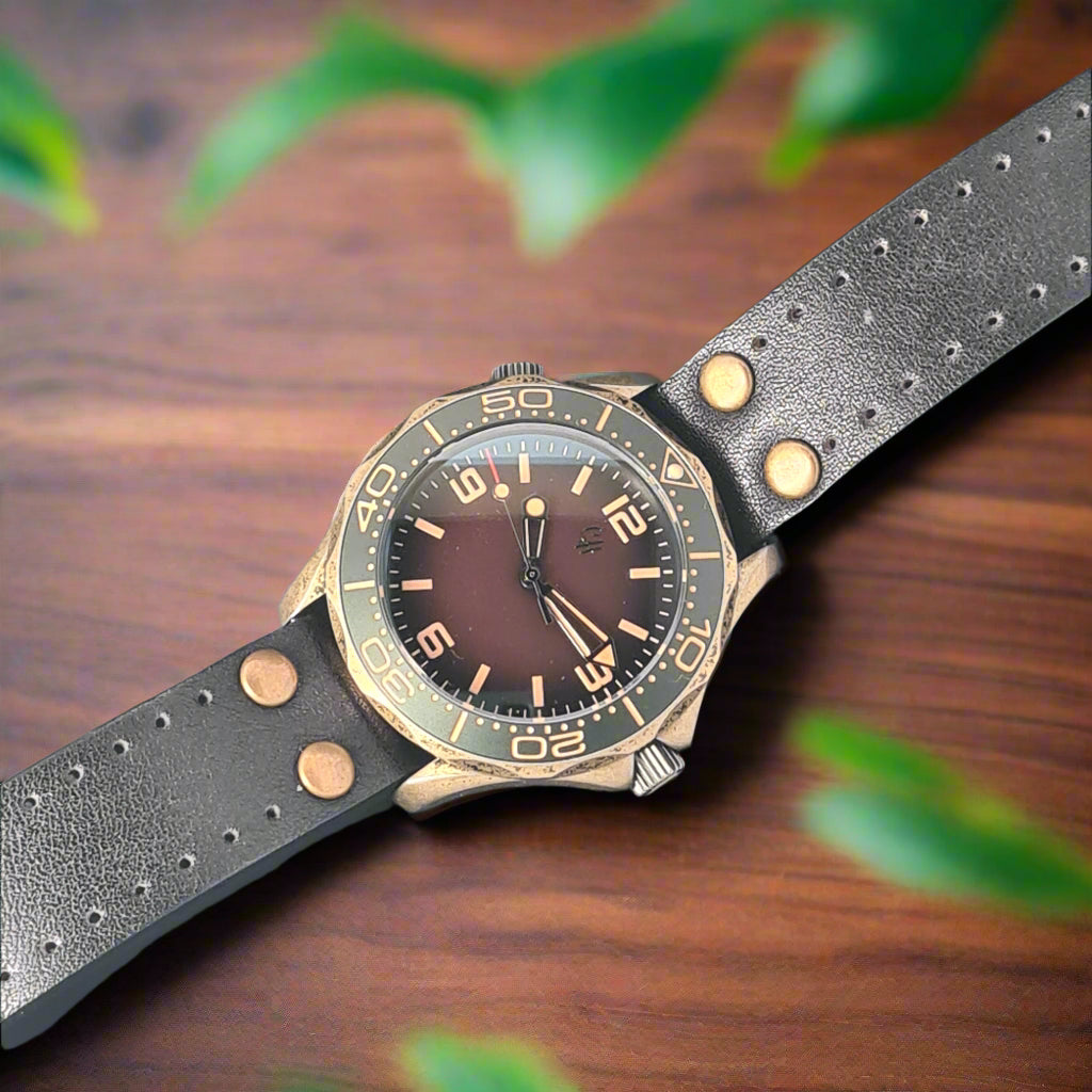 A bronze-toned watch with stainless steel case develops a unique patina over time, giving each watch its own character and story. At 39mm wide and 12mm thick, it’s built for durability yet comfortable enough for daily wear. The leather strap, detailed with brass rivets, reinforces its adventurous charm while adding tactile appeal.