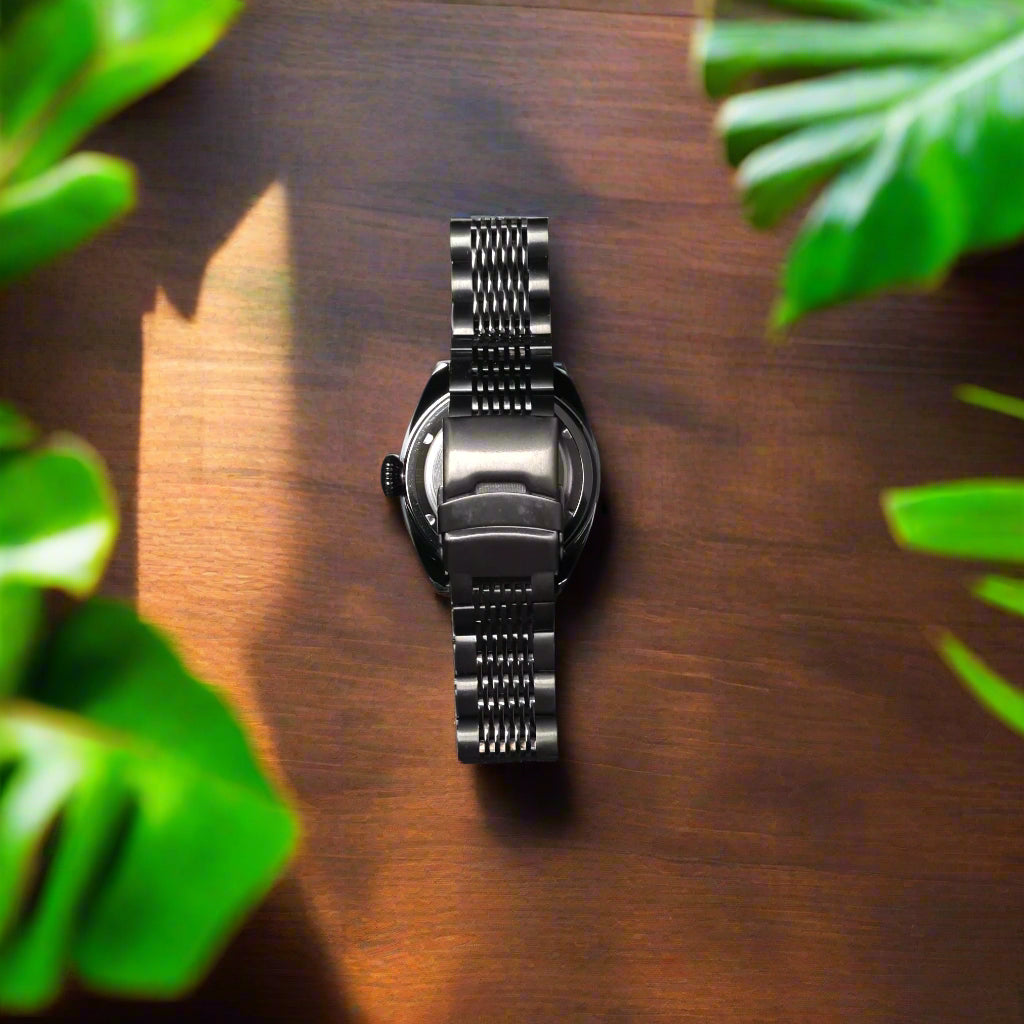 Metallic watch strap on a gray background