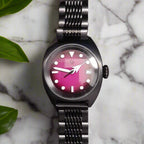 Black wristwatch with a pink face marble