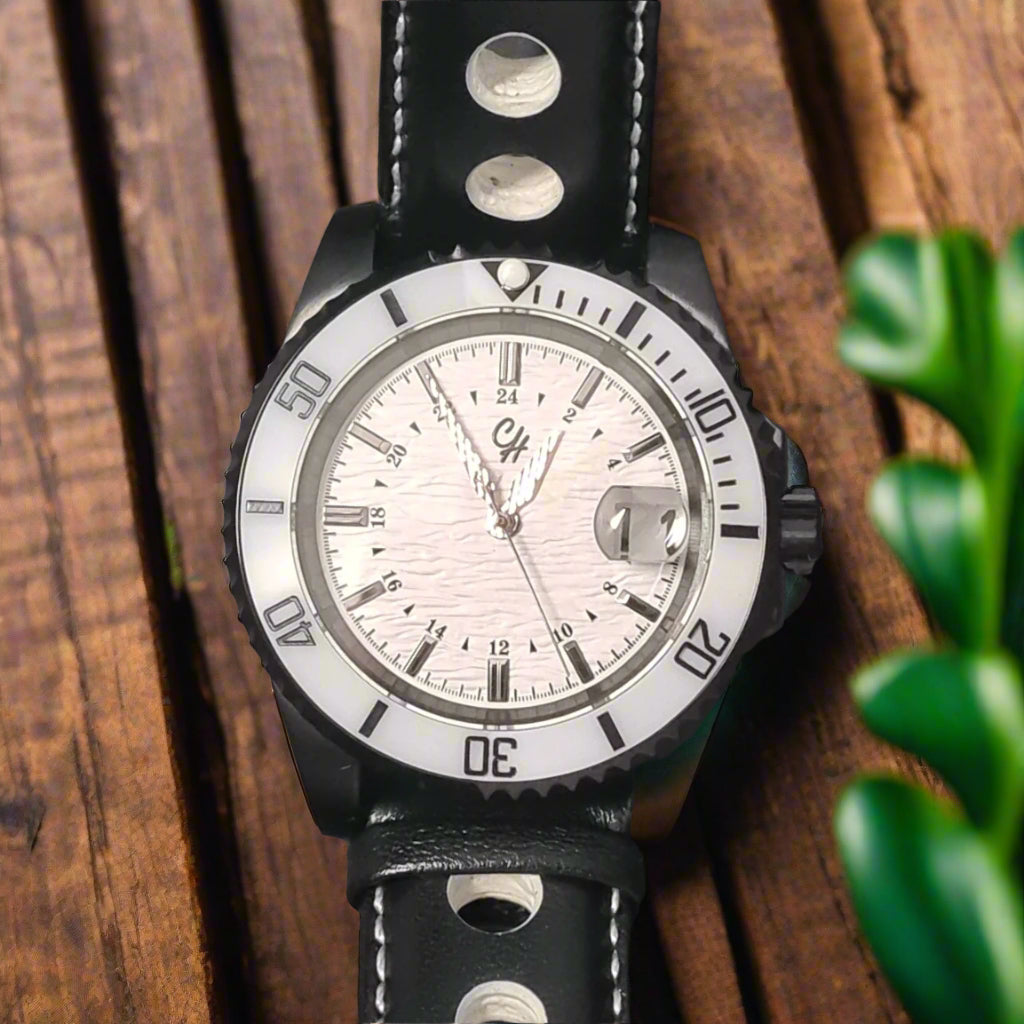 Wristwatch with black leather strap and silver case on a dark background