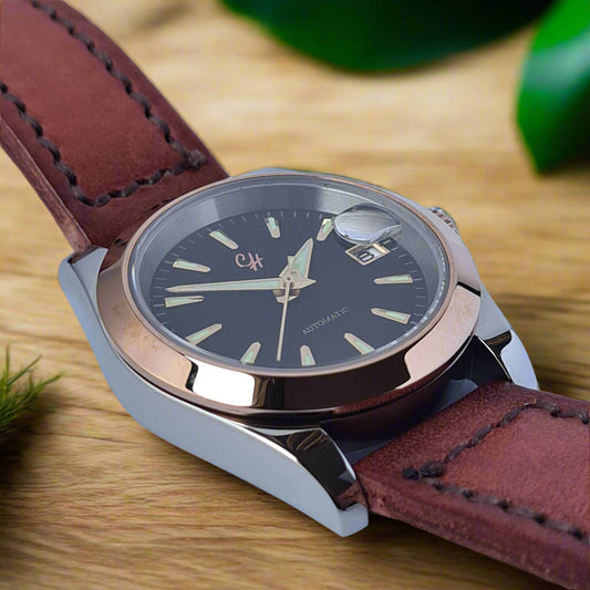 Watch with brown leather strap and rose gold case on light blue background