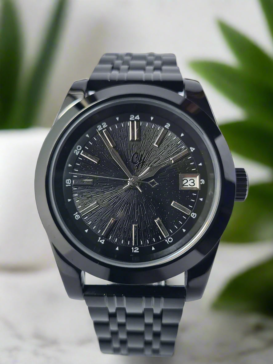 Black wristwatch with detailed face on a light gray background