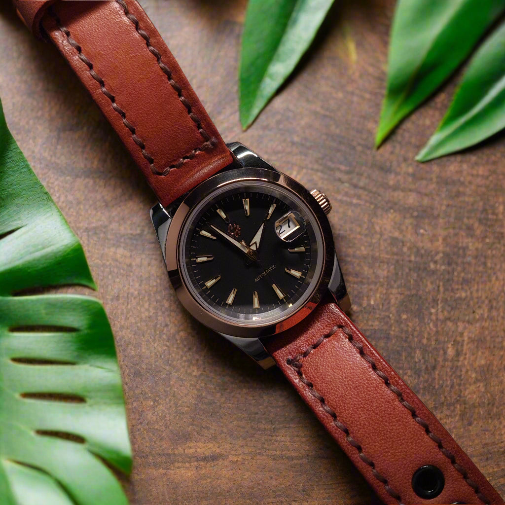 Watch with a brown leather strap on a textured dark background