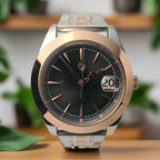 Luxury watch with rose gold and silver design on a light gray background
