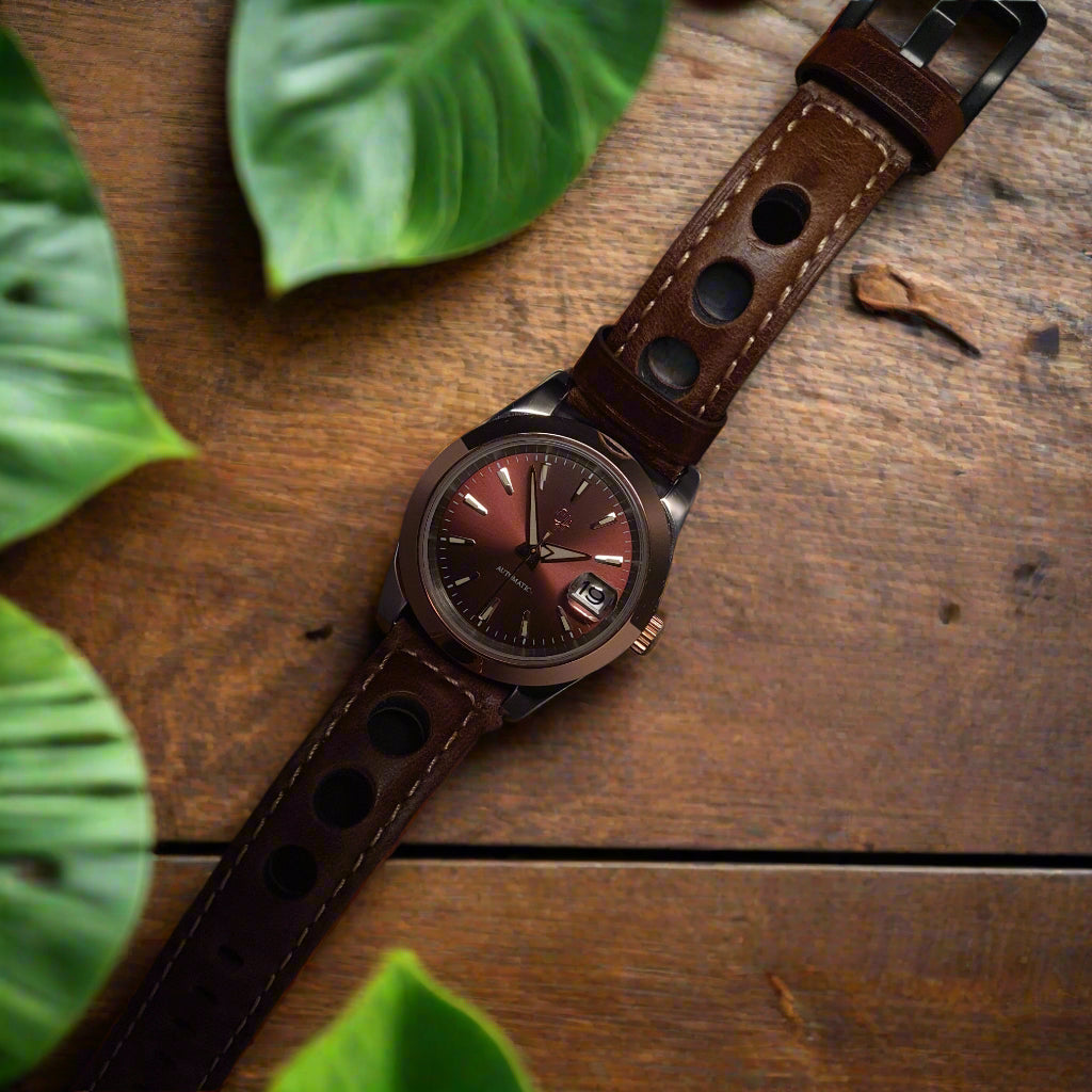 Watch with brown leather strap on a dark background