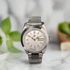 Silver wristwatch on a dark gray background