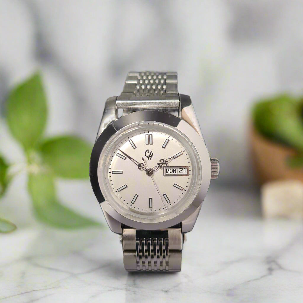 Silver wristwatch on a dark gray background