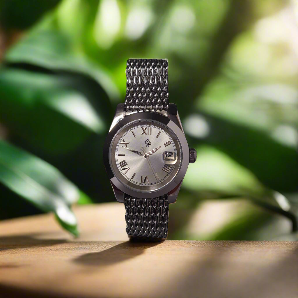 Silver watch with a chain strap on a black background