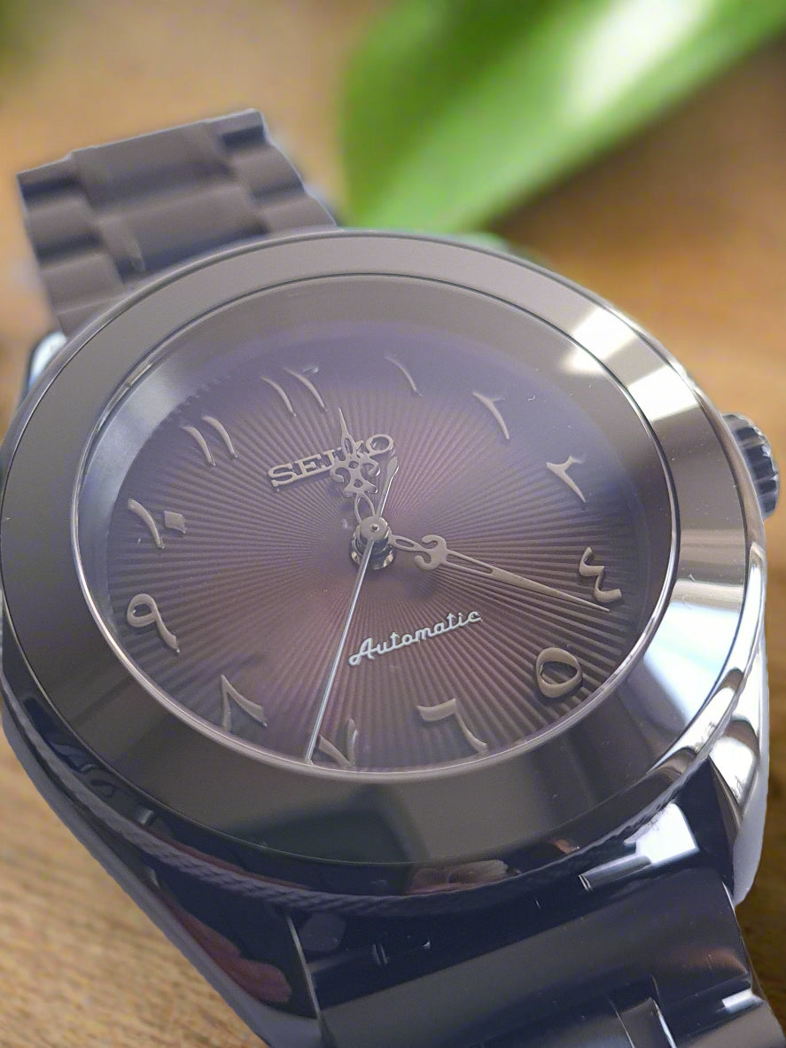 Silver watch with a detailed face on a table