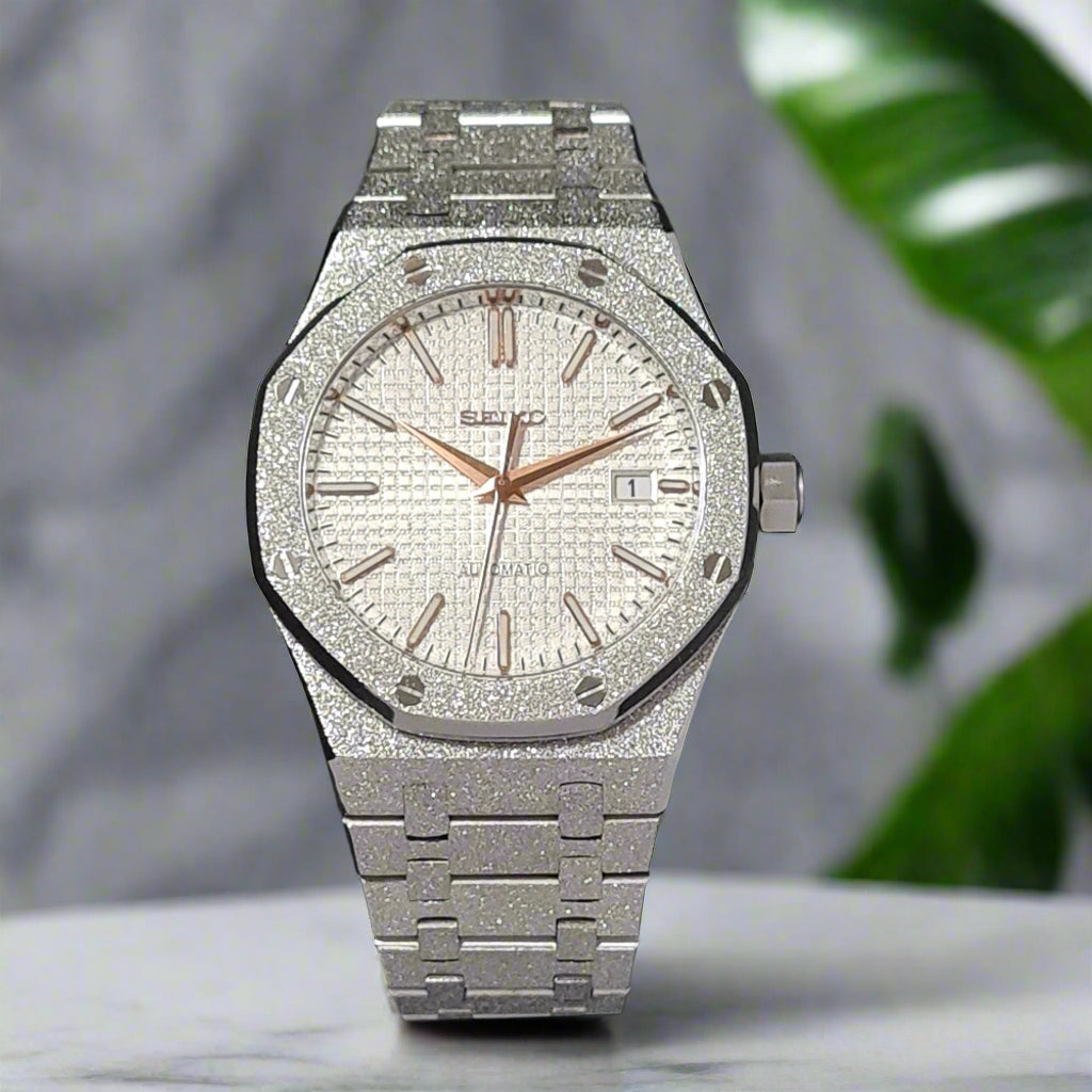 Silver watch with diamond-studded face on a marble background