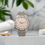 Silver watch with a detailed face on a marble bench