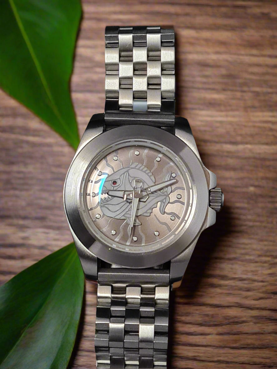 Silver watch with a detailed face on a table