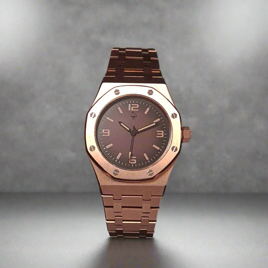Rose gold watch with dark face on a grey background
