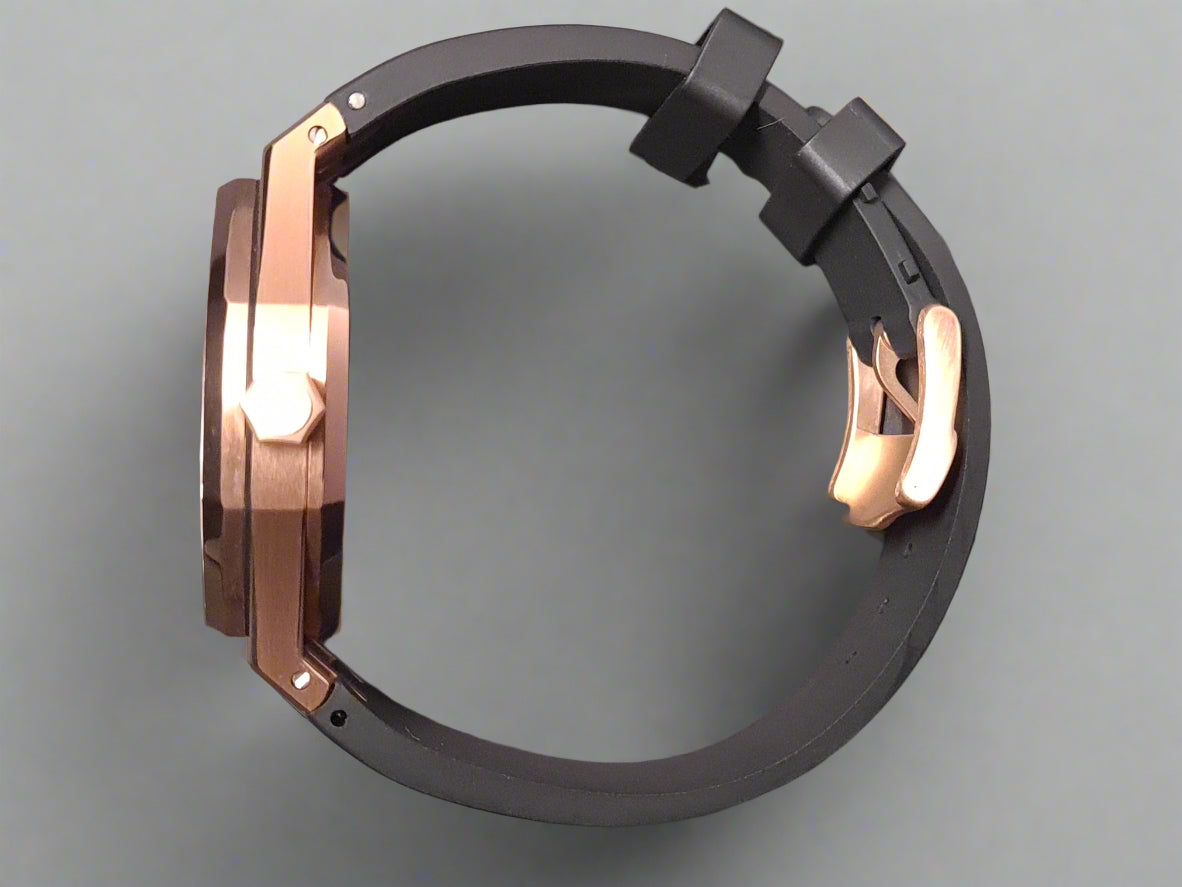 Black and rose gold watch case on a gray background