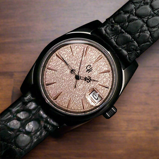 Watch with a glittery face and black leather strap on a dark background