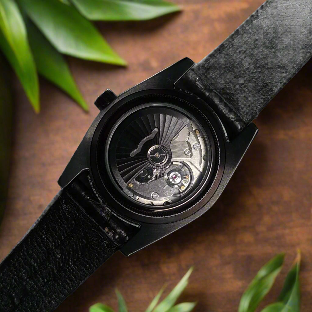 Black wristwatch with visible mechanical components on a dark background
