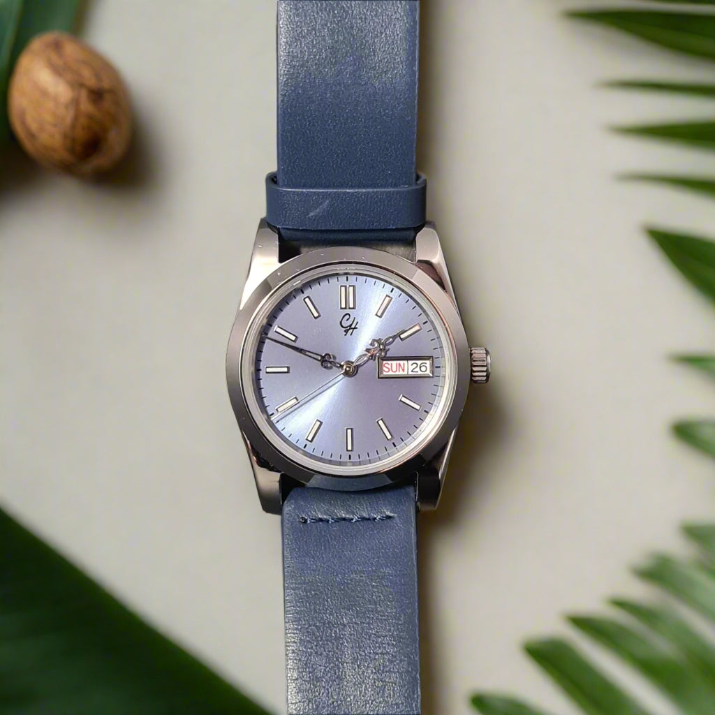 The Glacier features an ice blue sunburst dial inside a polished stainless steel case, paired with a deep blue calfskin leather strap. Powered by the reliable Seiko NH36, it delivers day/date practicality with a fresh, modern edge.