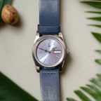 The Glacier features an ice blue sunburst dial inside a polished stainless steel case, paired with a deep blue calfskin leather strap. Powered by the reliable Seiko NH36, it delivers day/date practicality with a fresh, modern edge.