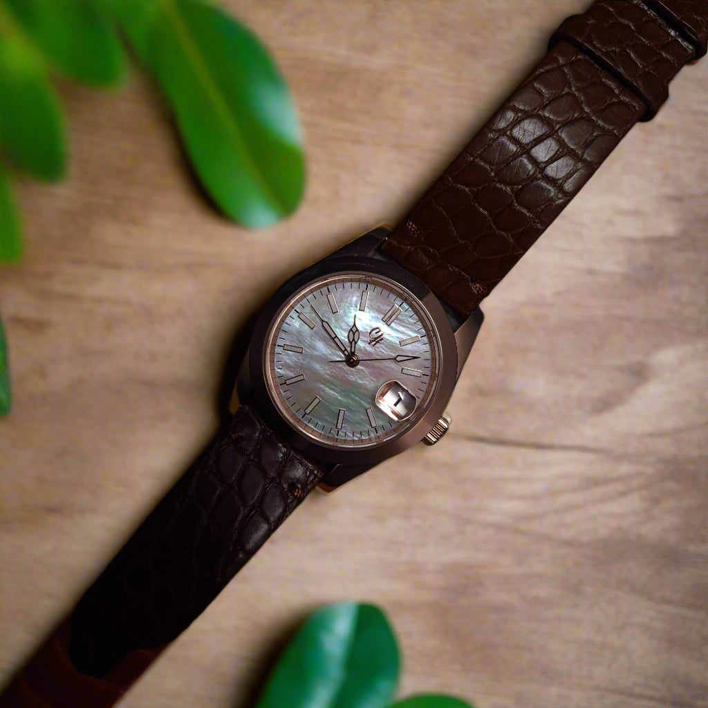 Wristwatch with brown leather strap on a timber table