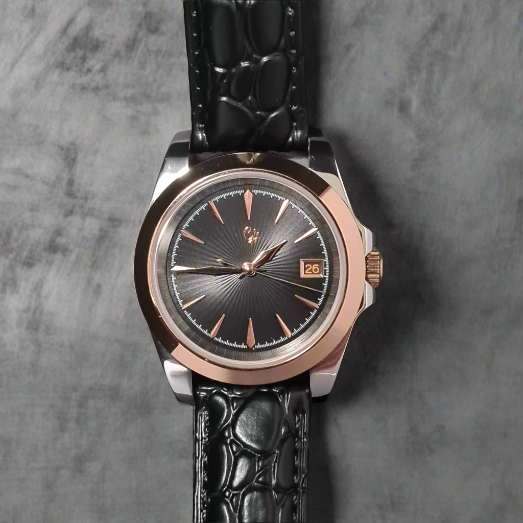Wristwatch with black strap and rose gold case on a dark background