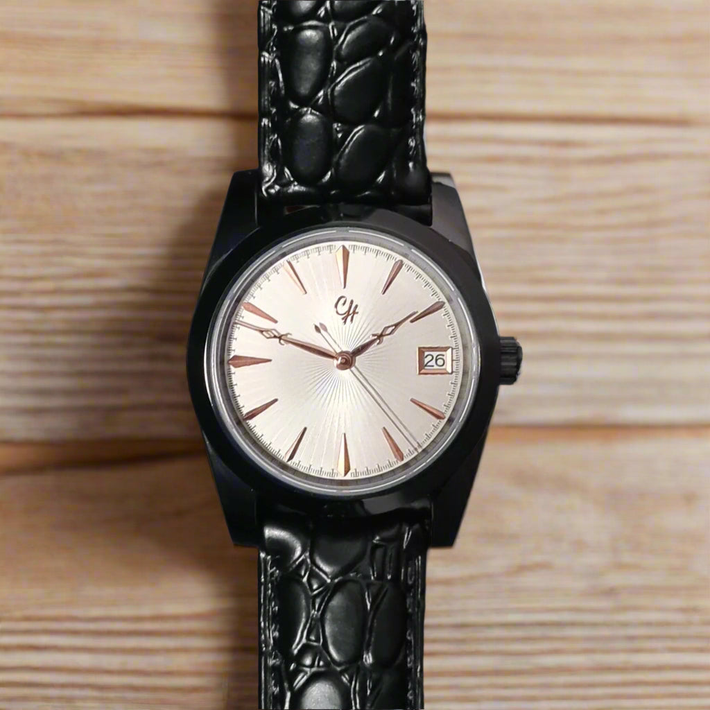 Black wristwatch with a textured strap on a wooden surface