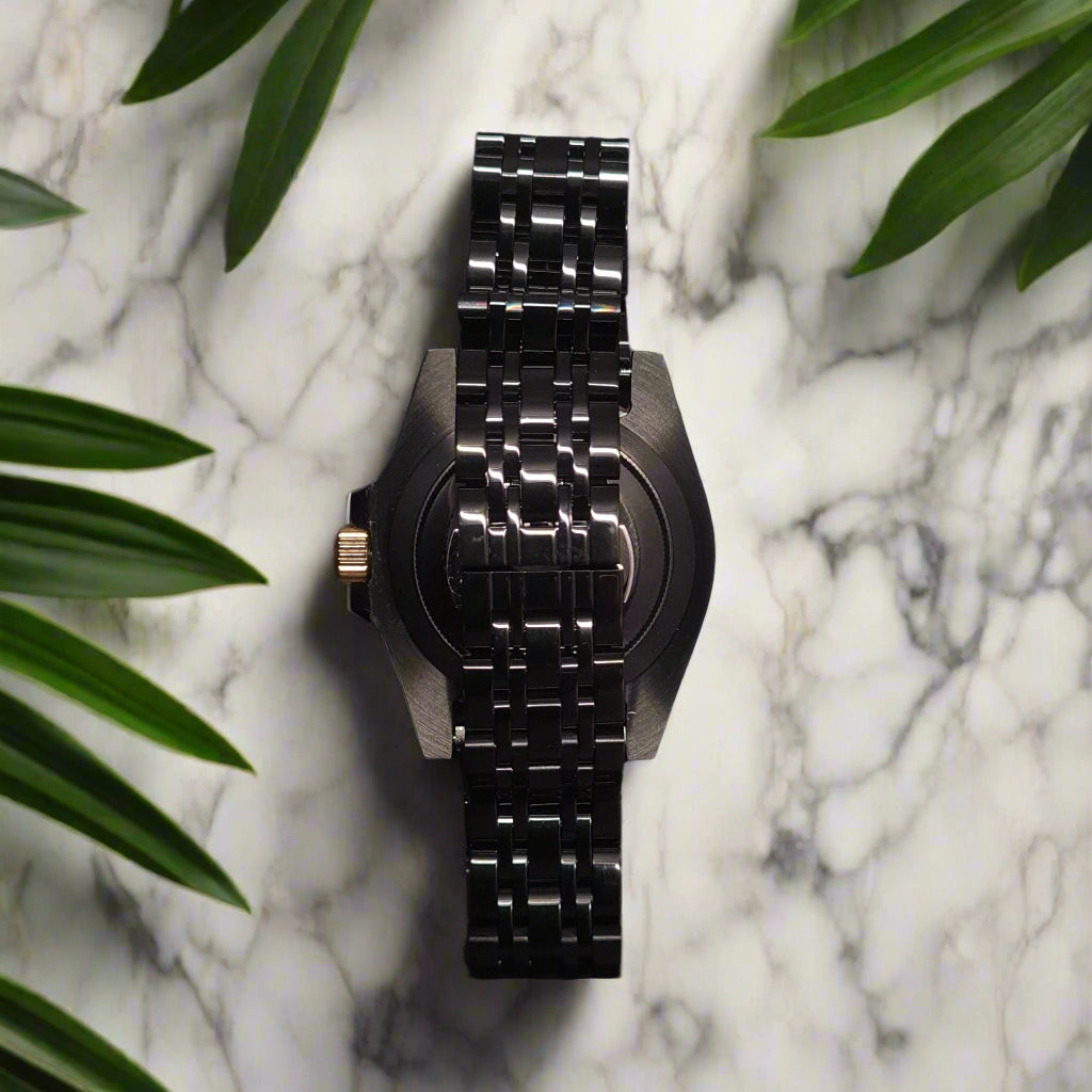 Black watch with metal bracelet on a dark background