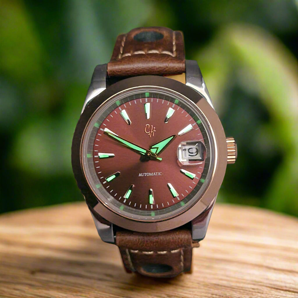 Watch with brown leather strap and reddish-brown dial on a dark background