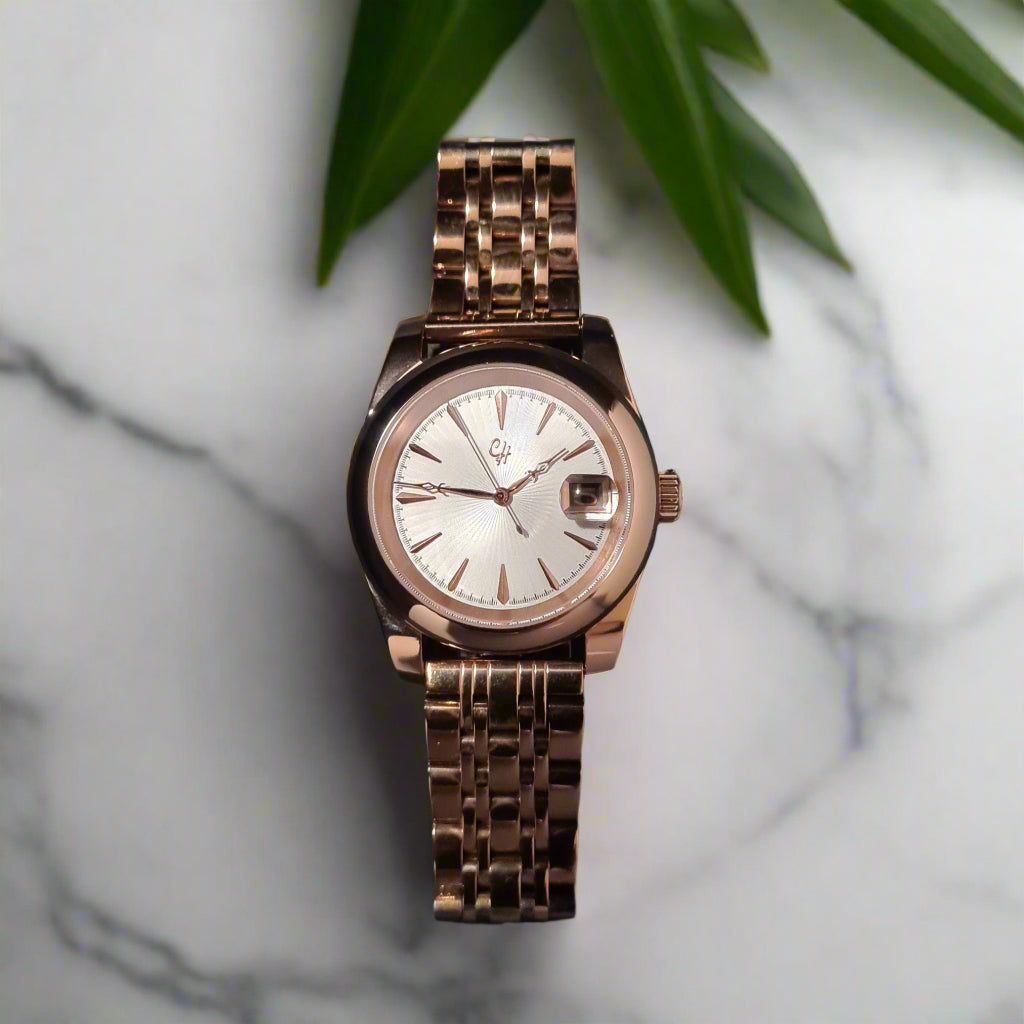Rose gold watch on a marble bench