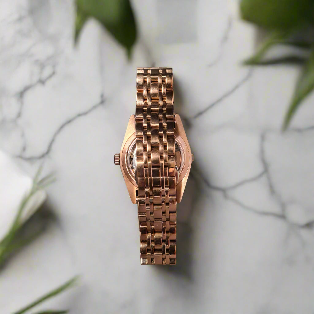 Rose gold watch on a marble background