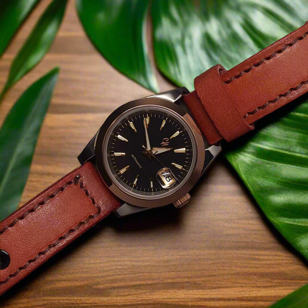 Watch with a brown leather strap on a black background