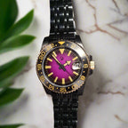 Wristwatch with black metal strap and purple face on a dark background