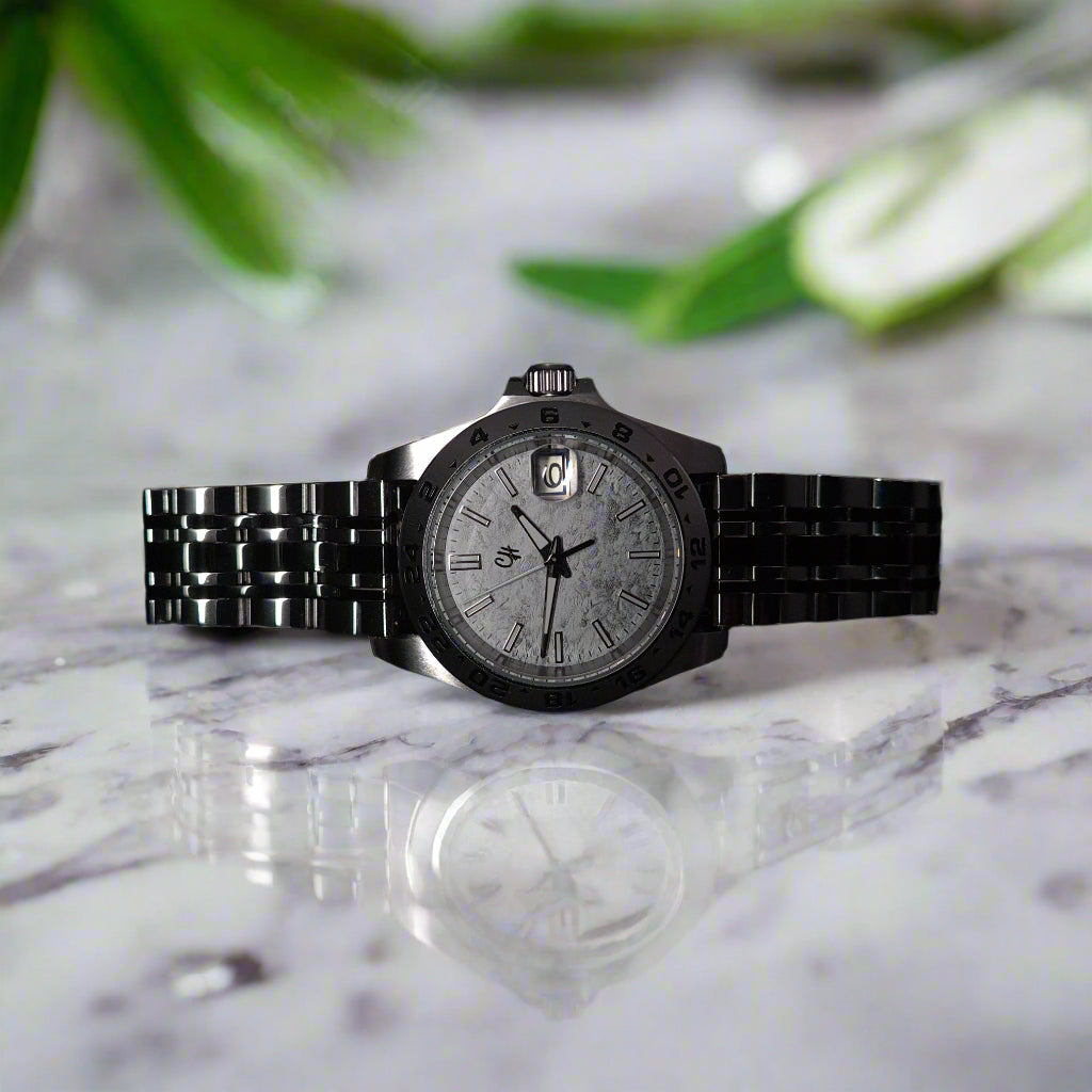 Silver wristwatch on a black background