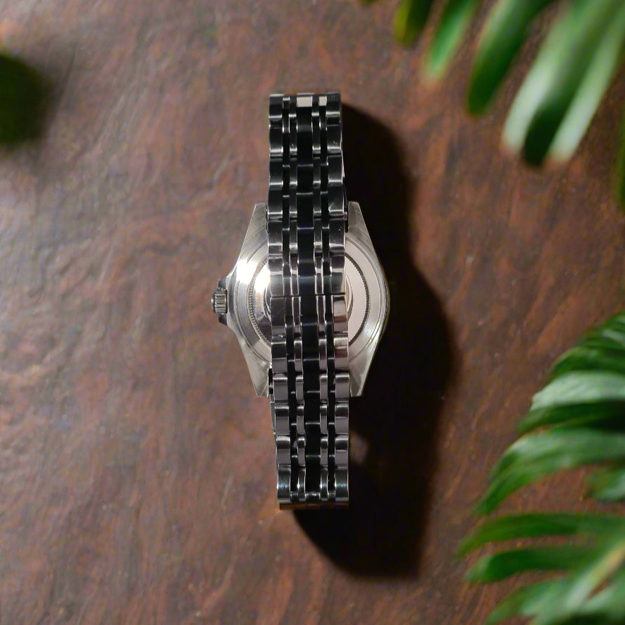 Metallic bracelet on a reflective gray surface