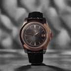 Wristwatch with black strap and metallic case on a dark background