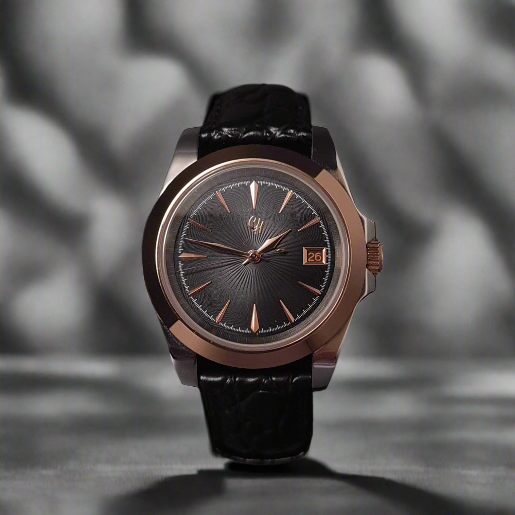 Wristwatch with black strap and metallic case on a dark background
