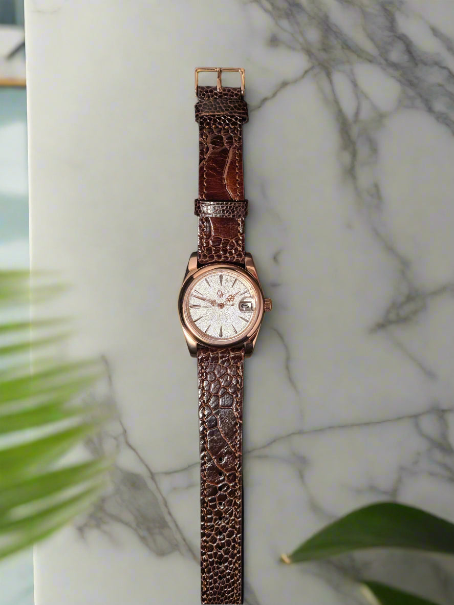 Watch with brown textured strap on a dark background