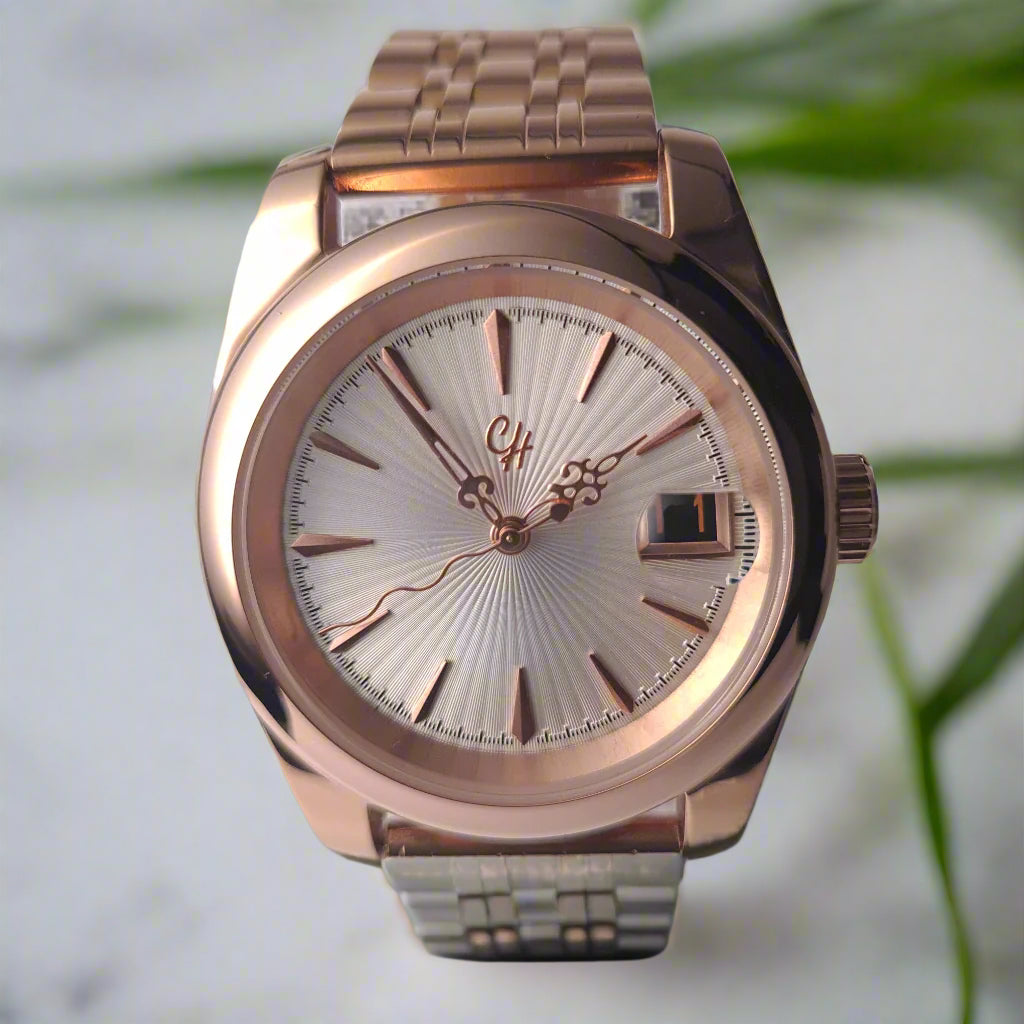 Rose gold watch with a detailed face on a light gray background